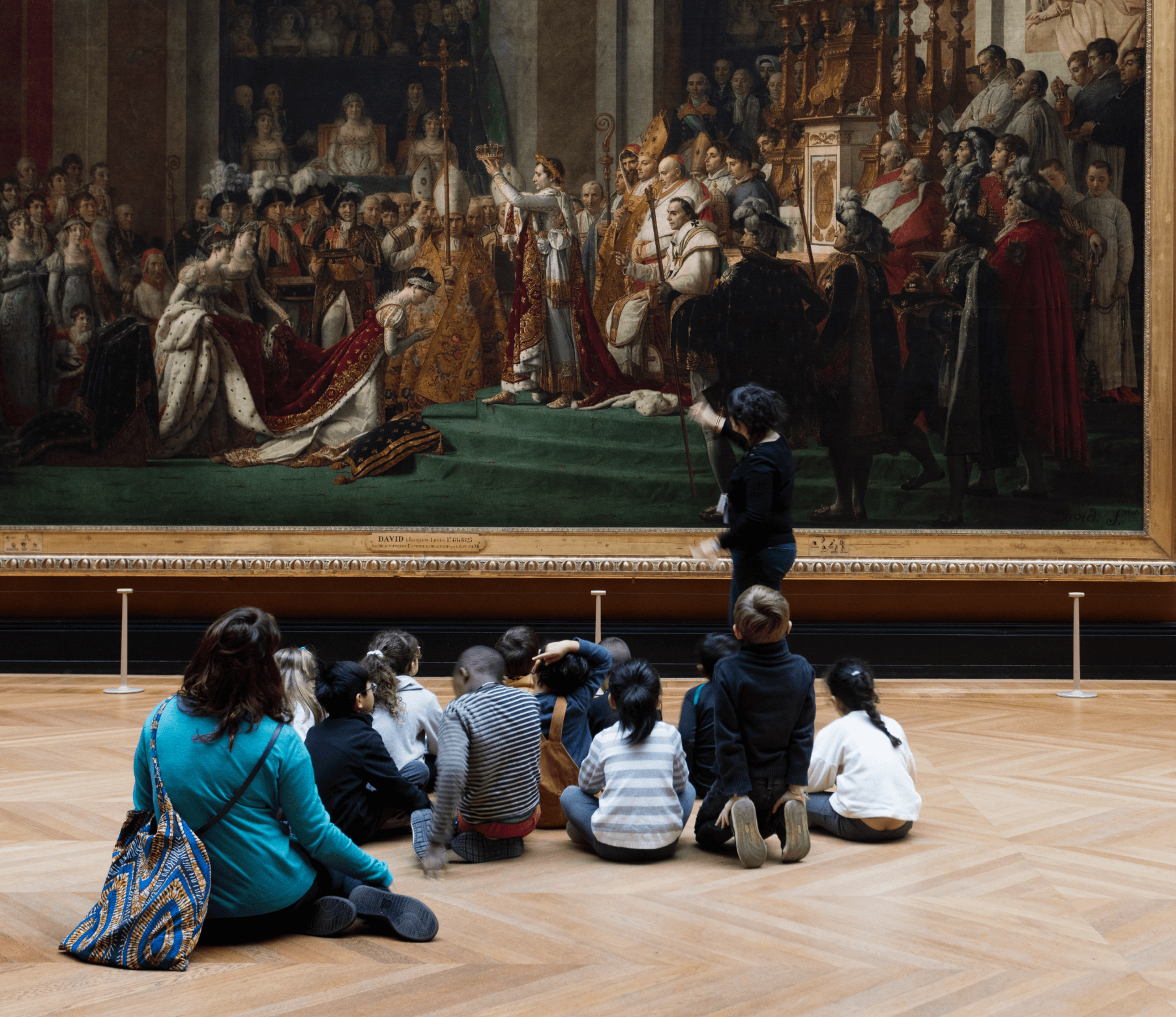 Louvre inspirational picture of an art teacher showing a group of kids a work of art inside Louvre museum